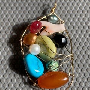 14k gold wire pendant with many different gemstones
